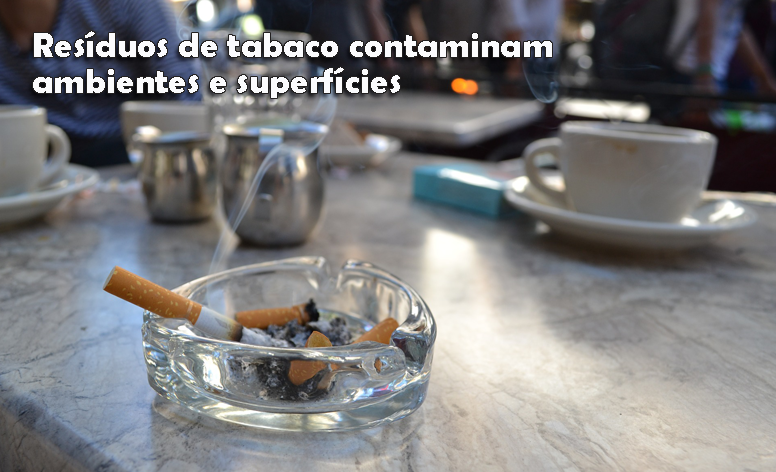 Foto de uma mesa de uma cafeteria, com um cinzeiro com cigarros apagados e um aceso